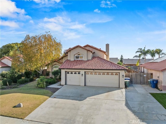 mediterranean / spanish home with a garage and a front lawn