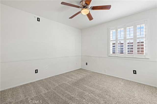 empty room featuring carpet flooring and ceiling fan