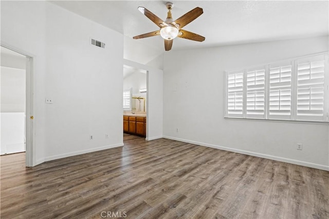 unfurnished living room with ceiling fan, hardwood / wood-style floors, and vaulted ceiling