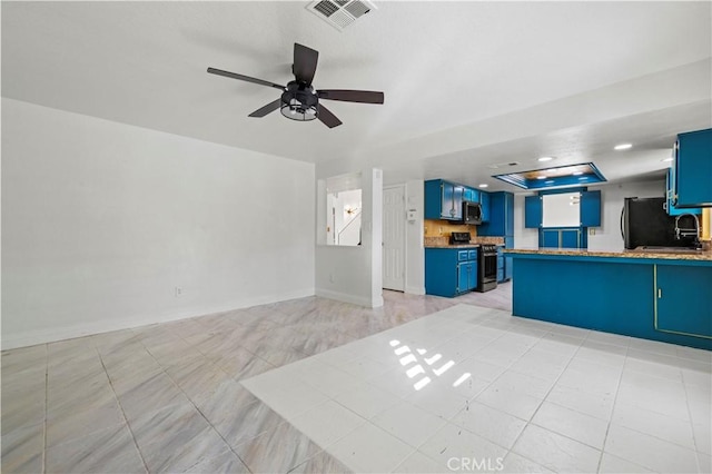 unfurnished living room featuring light tile patterned floors, ceiling fan, and sink