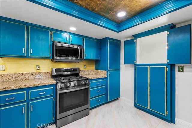 kitchen with a tray ceiling, crown molding, light stone countertops, and stainless steel appliances