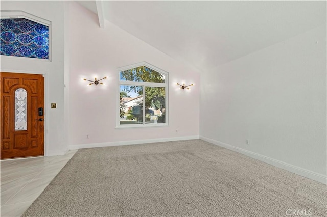 carpeted foyer with beamed ceiling and high vaulted ceiling