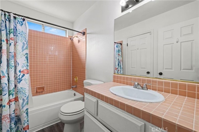 full bathroom with hardwood / wood-style floors, toilet, decorative backsplash, shower / bath combo with shower curtain, and vanity