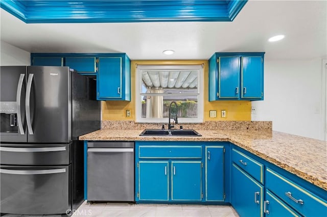 kitchen featuring blue cabinetry, appliances with stainless steel finishes, light tile patterned floors, and sink