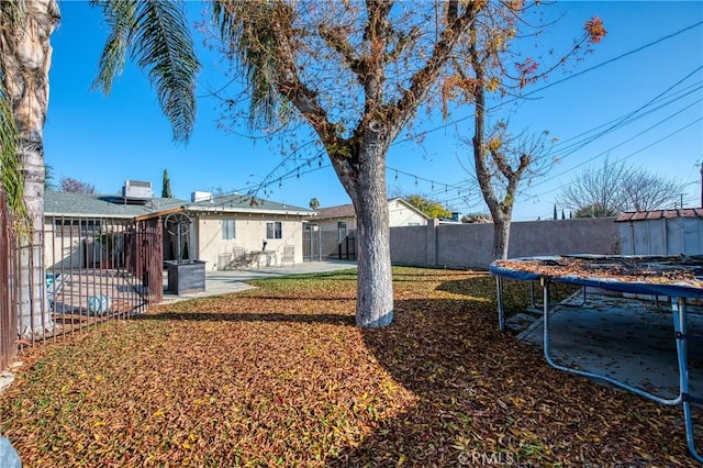 view of yard featuring a patio and a trampoline