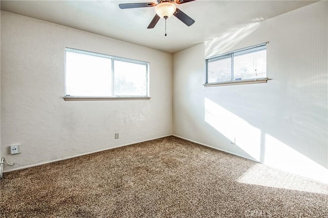 empty room featuring ceiling fan, carpet, and vaulted ceiling