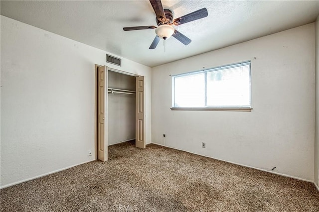 unfurnished bedroom with carpet flooring, a closet, and ceiling fan