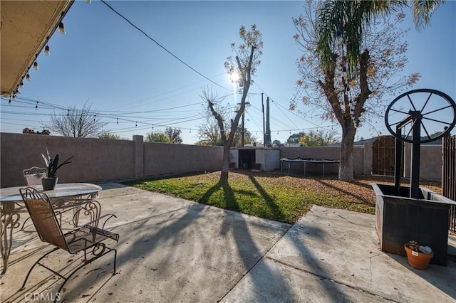 view of patio / terrace featuring a shed and a trampoline