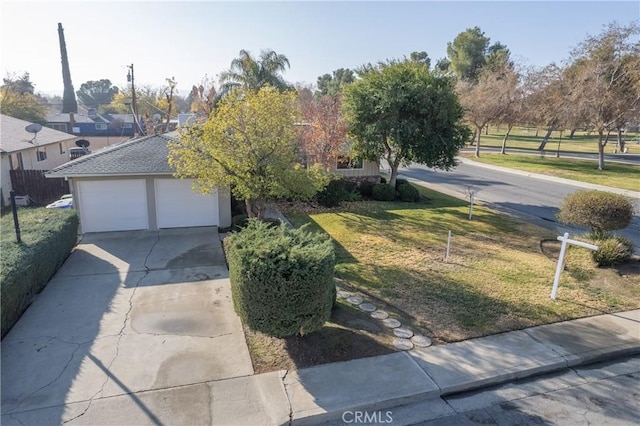 view of front of home with a garage and a front lawn