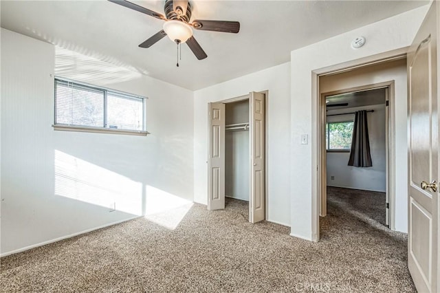 unfurnished bedroom with carpet floors, a closet, and ceiling fan