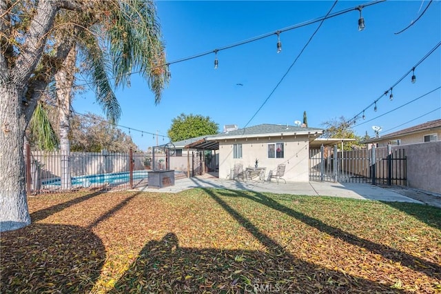 rear view of property featuring a yard and a patio