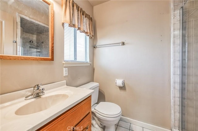 bathroom featuring tile patterned flooring, vanity, a shower with shower door, and toilet