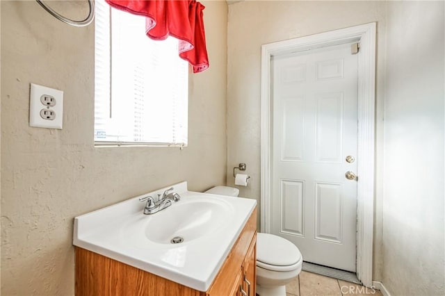 bathroom featuring tile patterned floors, vanity, and toilet