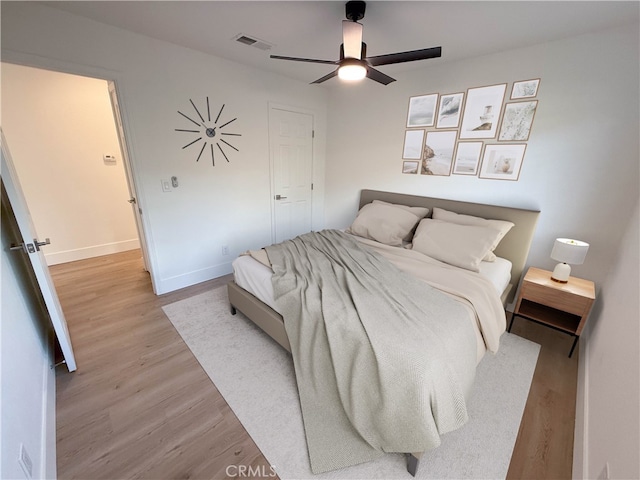 bedroom with ceiling fan and light wood-type flooring