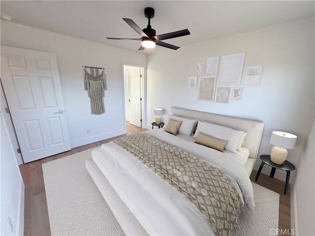 bedroom featuring wood-type flooring and ceiling fan