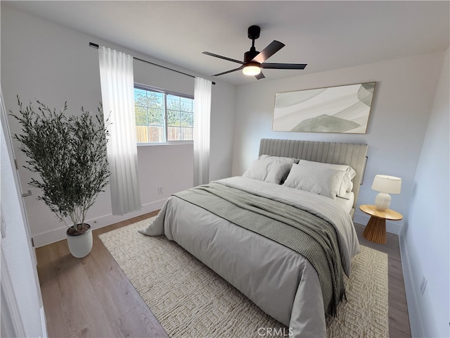 bedroom with ceiling fan and wood-type flooring