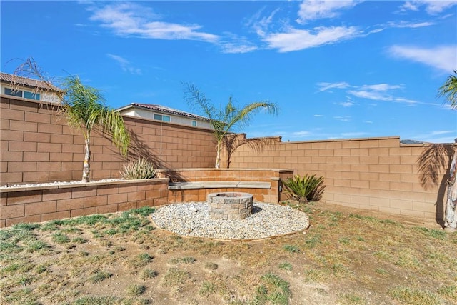 view of yard with a fire pit