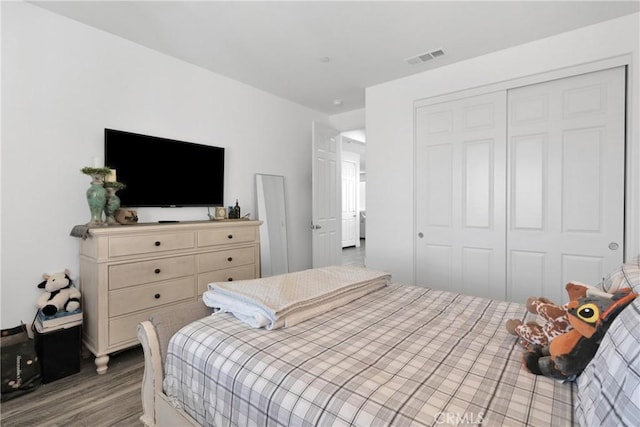 bedroom with wood-type flooring and a closet