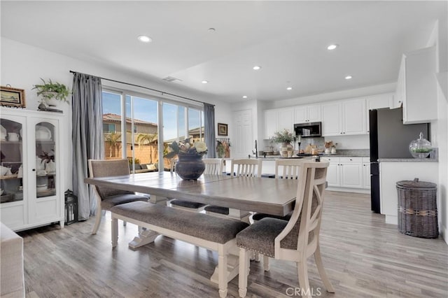 dining space featuring light wood-type flooring