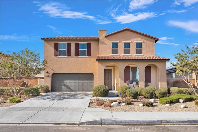 mediterranean / spanish-style house with a garage