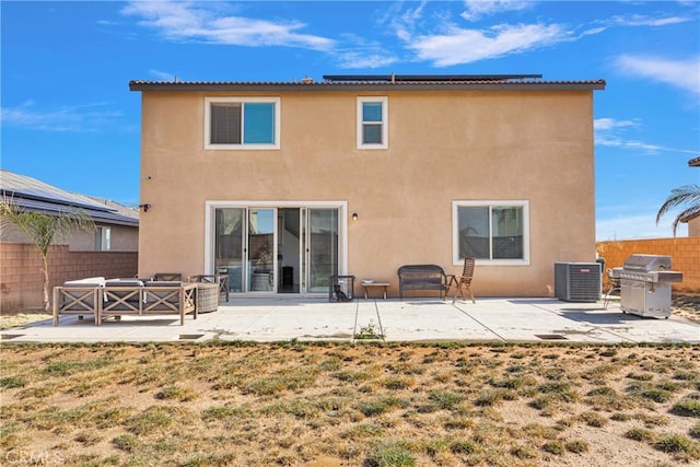 back of house featuring central air condition unit, a patio area, a lawn, and an outdoor hangout area