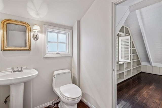 bathroom with toilet, hardwood / wood-style flooring, and sink