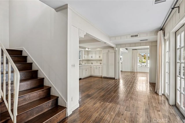 entryway with sink, dark hardwood / wood-style flooring, and ornamental molding