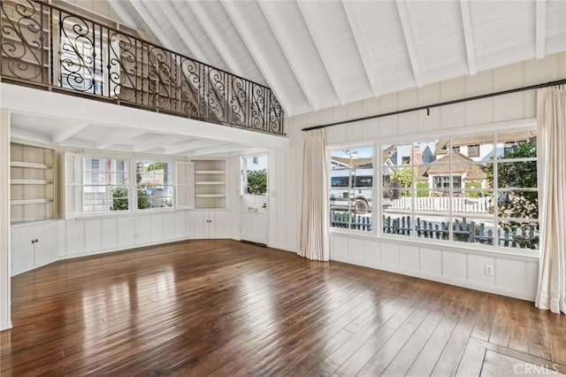 unfurnished sunroom featuring lofted ceiling with beams