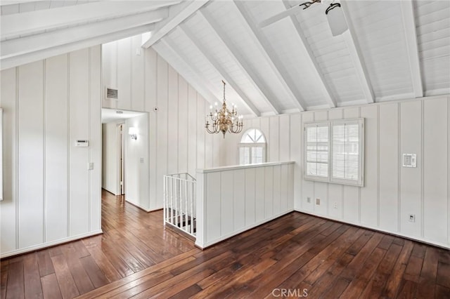 empty room featuring vaulted ceiling with beams, dark hardwood / wood-style flooring, and ceiling fan with notable chandelier