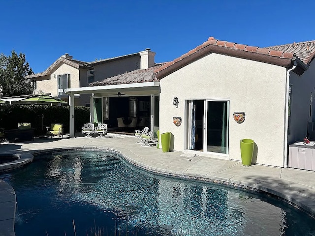 rear view of house featuring a patio and ceiling fan