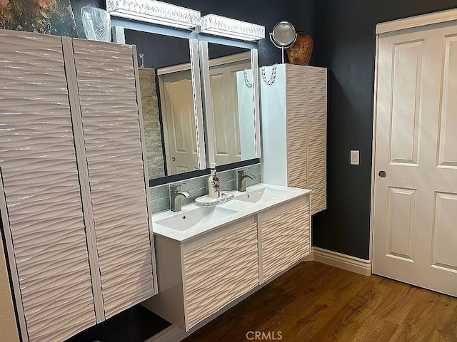 bathroom with hardwood / wood-style flooring and vanity