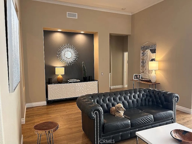 living room with wood-type flooring and ornamental molding