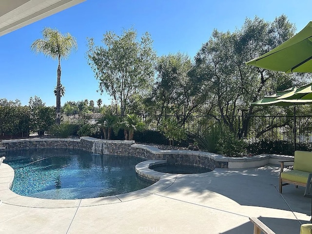 view of pool featuring an in ground hot tub and a patio