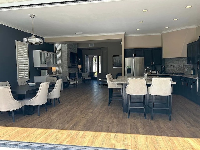 dining area featuring dark hardwood / wood-style flooring and crown molding