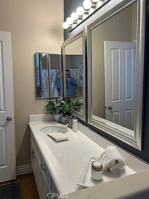 bathroom with wood-type flooring and vanity