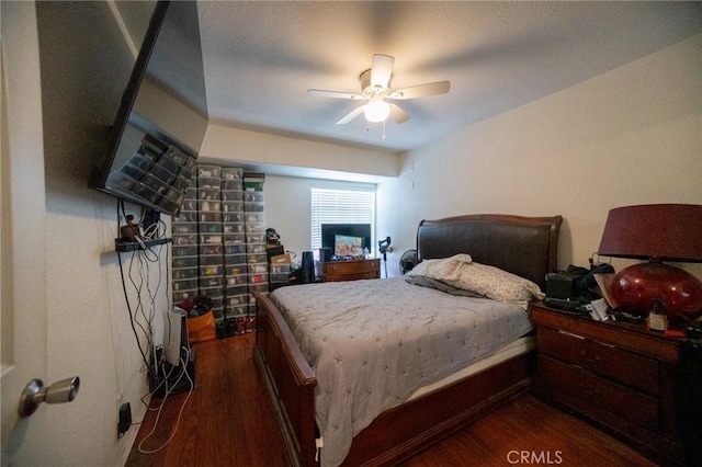 bedroom with ceiling fan and dark hardwood / wood-style flooring