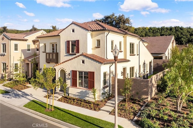 mediterranean / spanish-style home with a garage