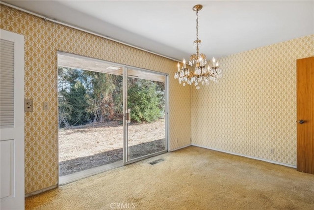 unfurnished dining area with carpet and a chandelier