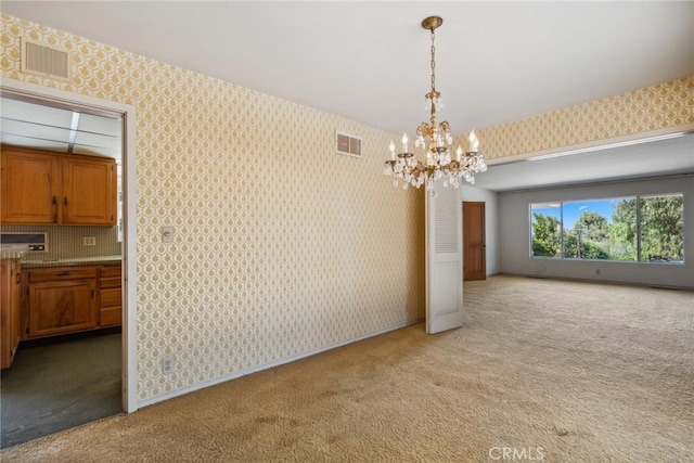 unfurnished dining area with light colored carpet and a chandelier