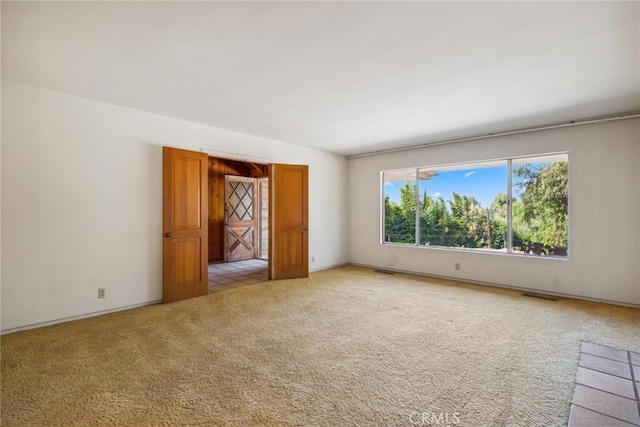 empty room featuring light carpet