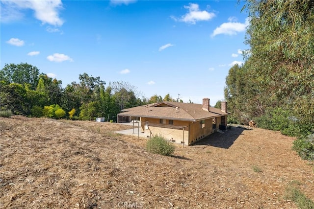 view of side of property with a patio