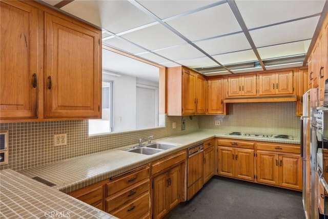 kitchen featuring dishwashing machine, backsplash, white gas cooktop, and sink