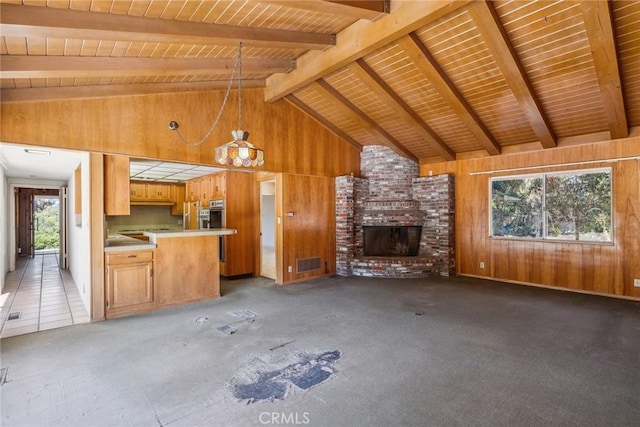 unfurnished living room with wooden ceiling, high vaulted ceiling, wooden walls, a brick fireplace, and beam ceiling