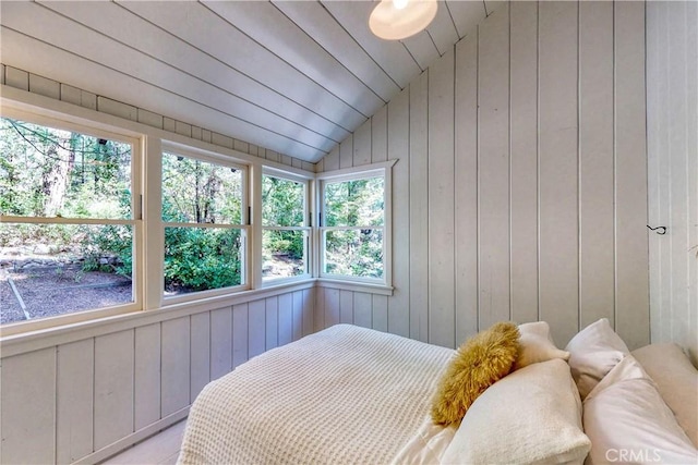 bedroom with wood walls, wooden ceiling, and lofted ceiling