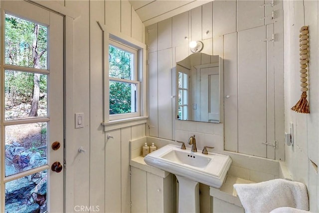 bathroom featuring lofted ceiling and a healthy amount of sunlight