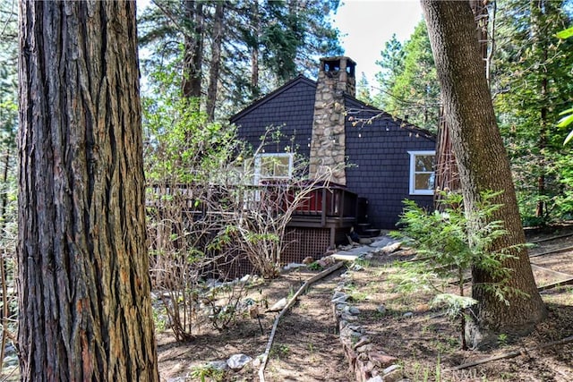 view of side of property featuring a wooden deck