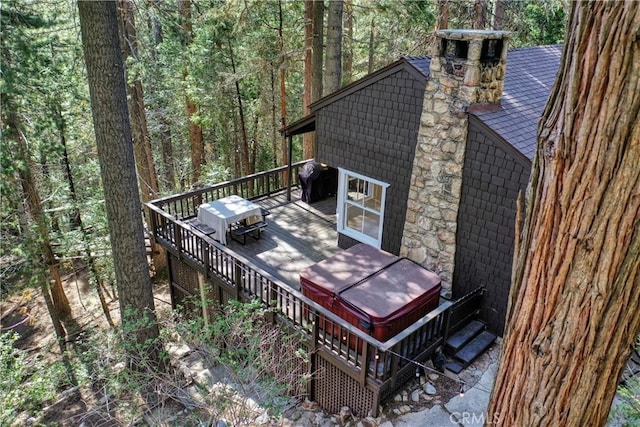 wooden terrace featuring area for grilling and a hot tub