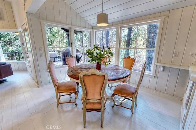 sunroom / solarium with a healthy amount of sunlight and lofted ceiling