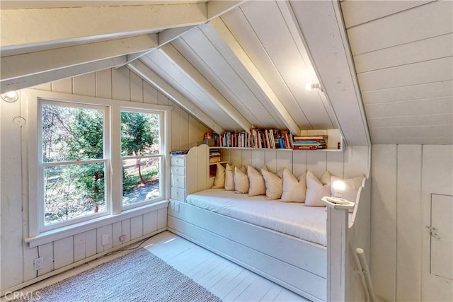 interior space with lofted ceiling and wood walls