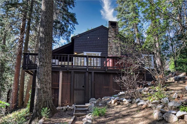 rear view of house featuring a deck